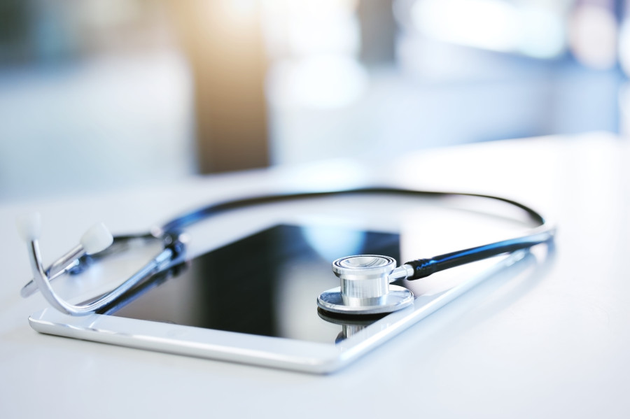 Stethoscope lies on a tablet, the background is blurred