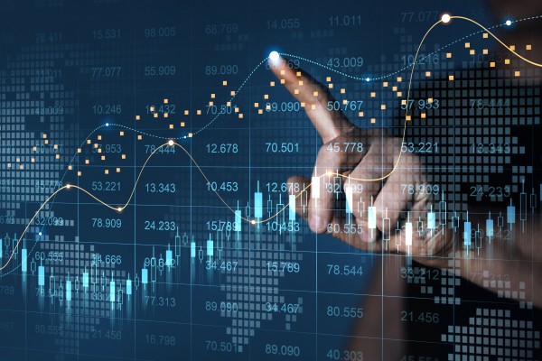 s pane on which data and graphs are projected. From the other side, a finger can be seen tapping on the glass.