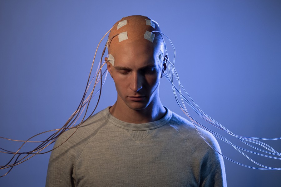 A Human who is connected to a Computer with cabels