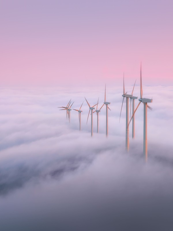 wind turbines over clouds